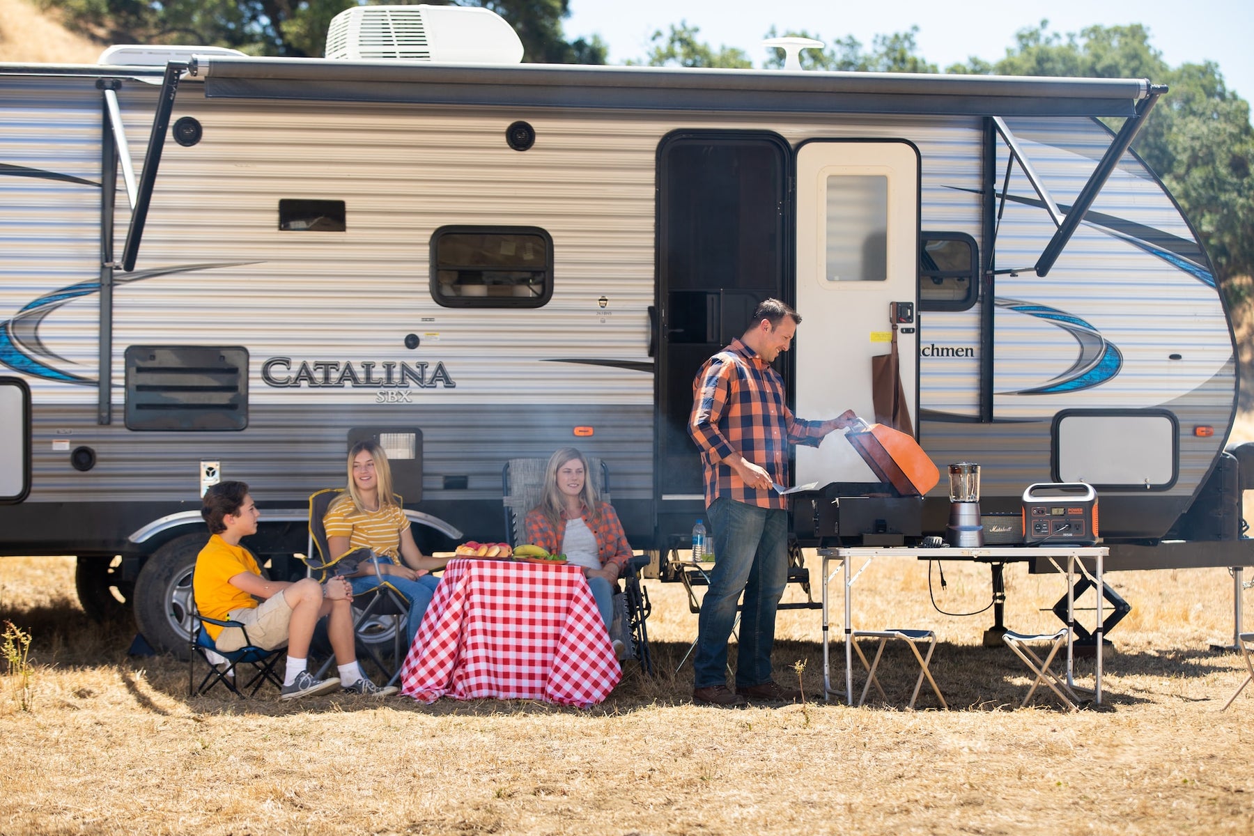 Portable generator with camper and a family