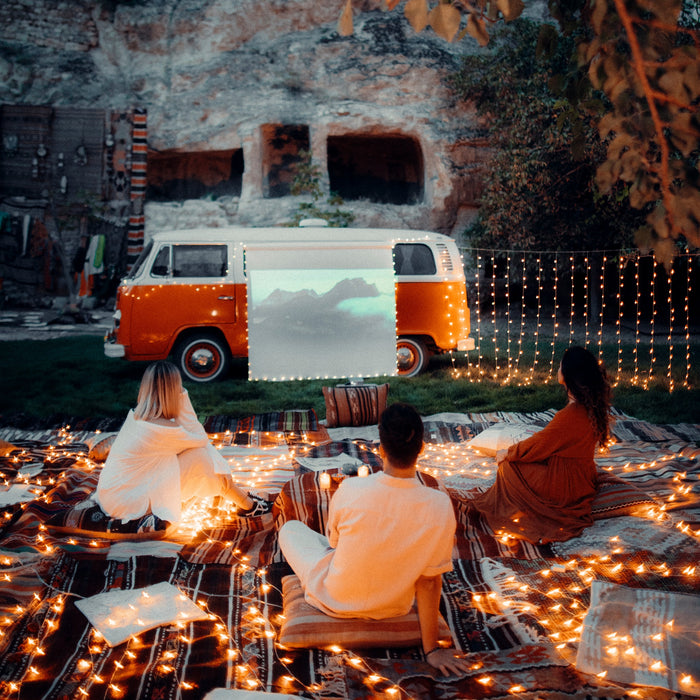 Campers watching a movie with a generator for camping