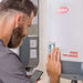 A technician adjusts the settings on a Fronius Symo Advanced inverter while holding a smartphone, demonstrating interaction with Fronius Primo Inverter-6.0kW-4,210,062,800