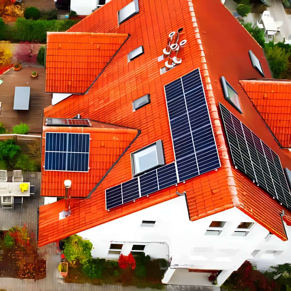 Aerial view shows a house with multiple solar panels on its red roof and the Tigo Energy 200A Automatic Transfer Switch 801-200200-0201