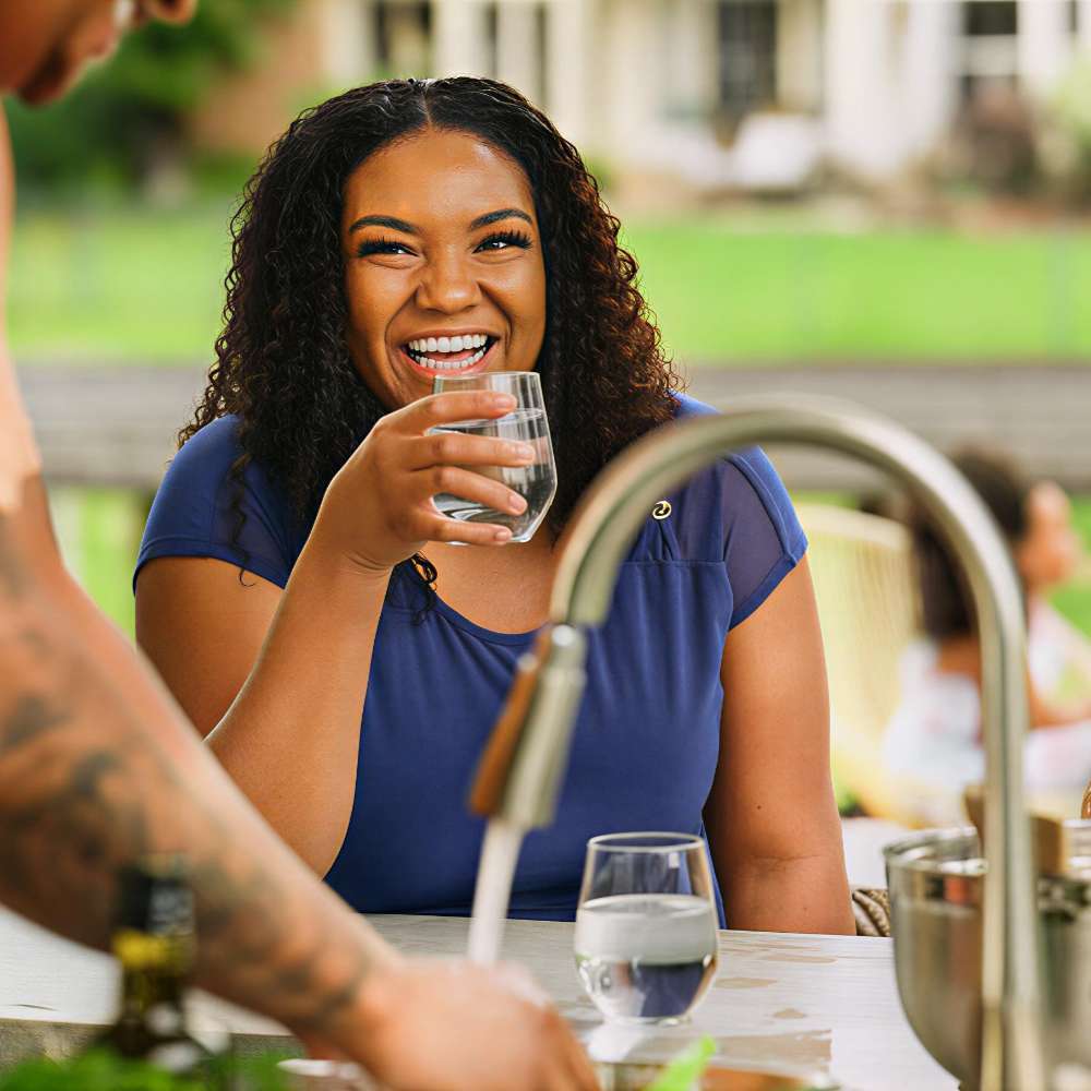 Clean water access is shown by a woman drinking from a glass, linked to systems using the Grundfos GRFSFSW Float Switch