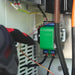 Gloved hand works inside an electrical box with a green Tigo device and wiring connected to the Tigo Energy 200A Automatic Transfer Switch w Generator Support-801-200200-0301