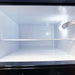 Interior freezer view shows SunStar ST-16RF-SS 16 cu.ft. DC/AC Refrigerator - Stainless Steel with a white compartment, wire shelf, and bright light