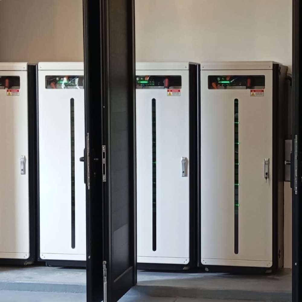 Multiple tall white battery cabinets standing in a room behind an open door represent the Pytes Forest RB 6 Slot Battery Cabinet for E-Box-48100R - 110409100166