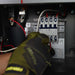 Outback Power FXR Sealed E Series FXR2012E 2000W 12VDC Inverter/Charger shown with a technician tightening wiring inside an electrical panel