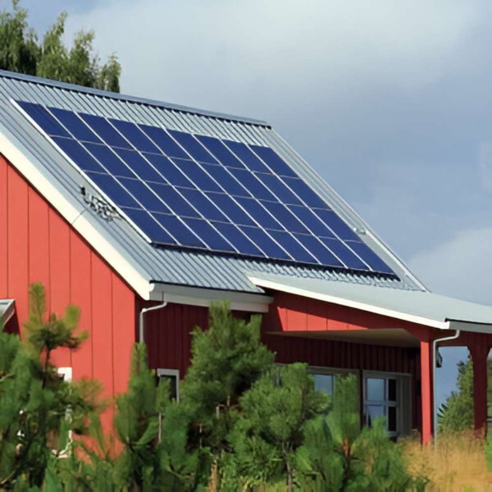 Red house with solar panels installed on its roof, suggesting a residential solar system that could use a Magnum Energy MS-PE Series MS4348PE 4300W 48VDC Pure Sine Inverter Charger