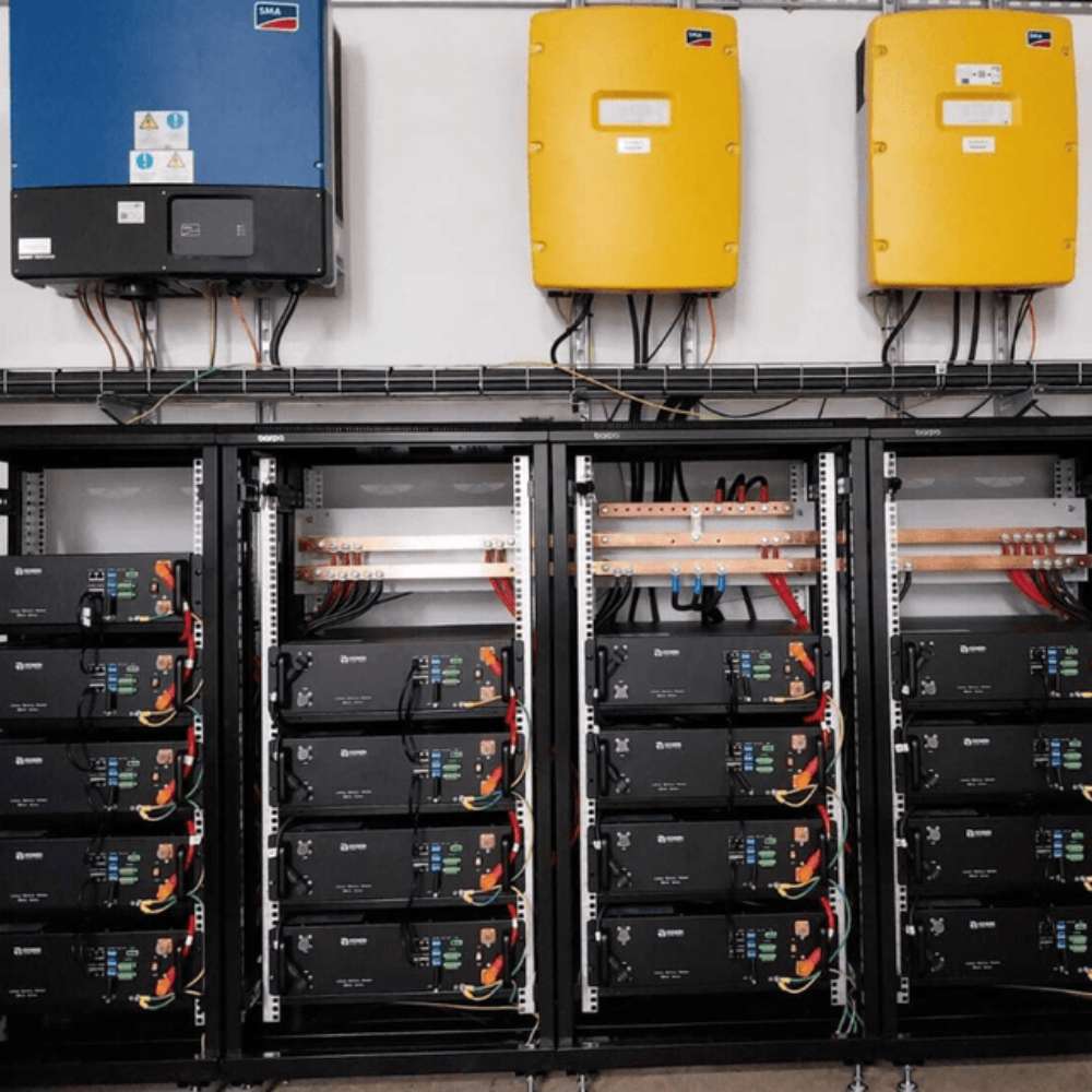 Renon Power EBrick Rack Series 5.12 kWh LiFePO4 Stackable Battery Module w/ Heat-EBRICKRH5K is stacked inside tall server-style racks in a large commercial energy system