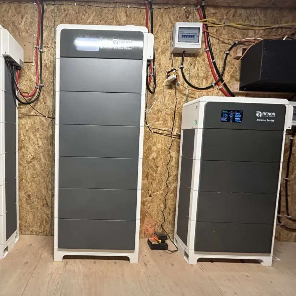 Renon Power Xtreme LV Series 5.12KWh Stackable Battery Module-XTREMELVBCU is displayed as two stacked battery towers installed inside a utility room with visible wiring