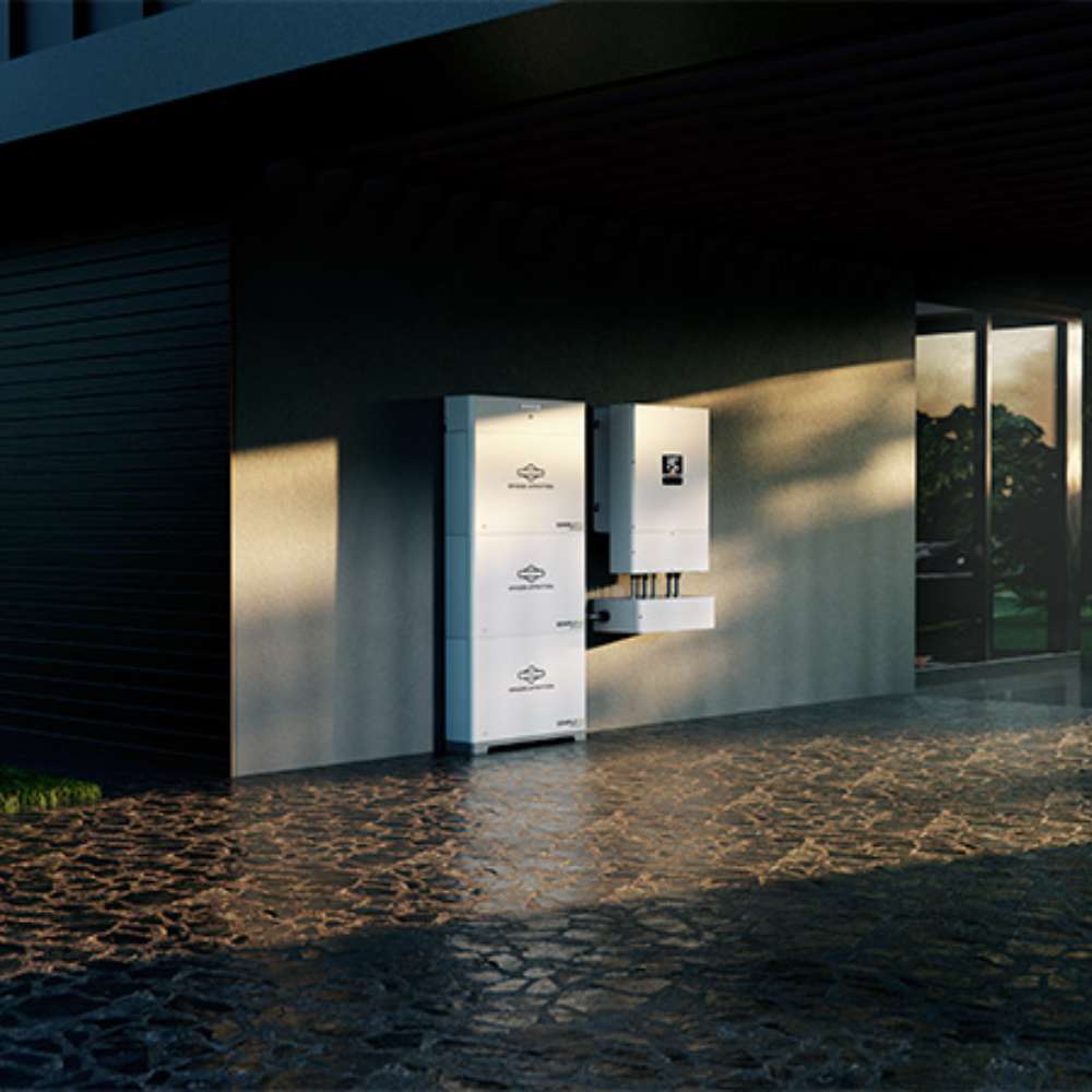 Simpliphi by Briggs & Stratton PHI-1.4-12-T 12 Volt 1.4kWh Lithium Battery is shown installed on the exterior wall of a modern home as part of a clean, wall-mounted residential energy storage system