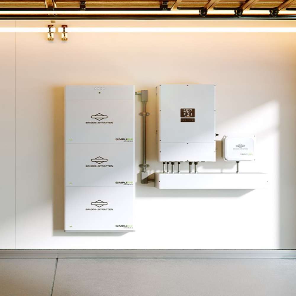Simpliphi by Briggs & Stratton SPHI-B-6.6BA 6.6kWh Stackable Lithium Battery shown as multiple white battery units stacked and wall-mounted beside an inverter in a clean indoor space