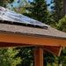 Solar panels on a wooden structure’s roof reflect sunlight for use with the Magnum Energy MS-PE Series MS4124PE 4100W 24VDC Pure Sine Inverter Charger