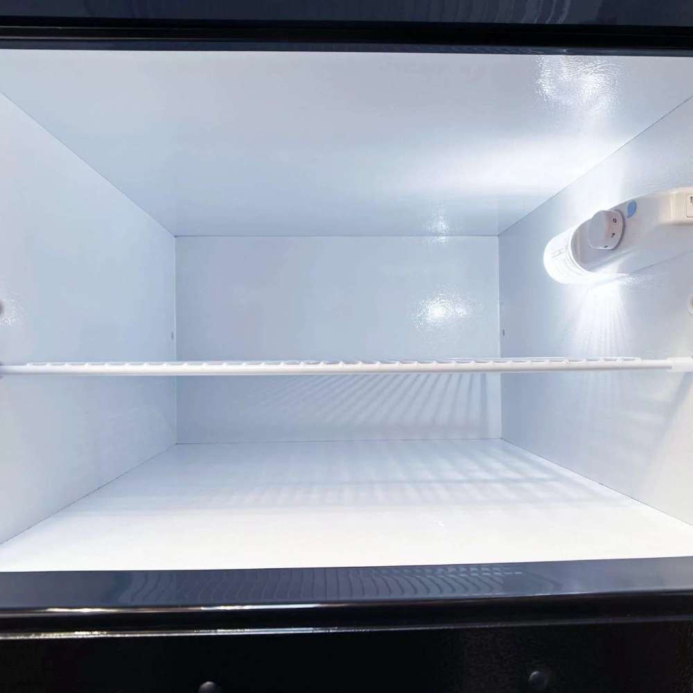 SunStar ST-16RF-B 16 cu.ft. DC/AC Refrigerator - Black interior freezer compartment is shown empty, with a white interior, a single wire shelf, and a small interior light