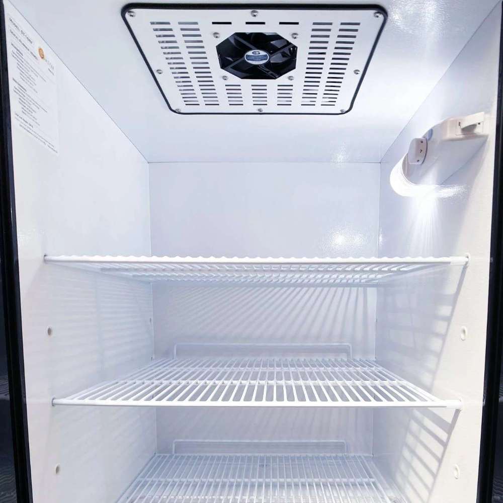SunStar ST-16RF-B 16 cu.ft. DC/AC Refrigerator - Black refrigerator compartment is shown empty, featuring multiple white wire shelves, a ceiling-mounted cooling fan, and bright lighting