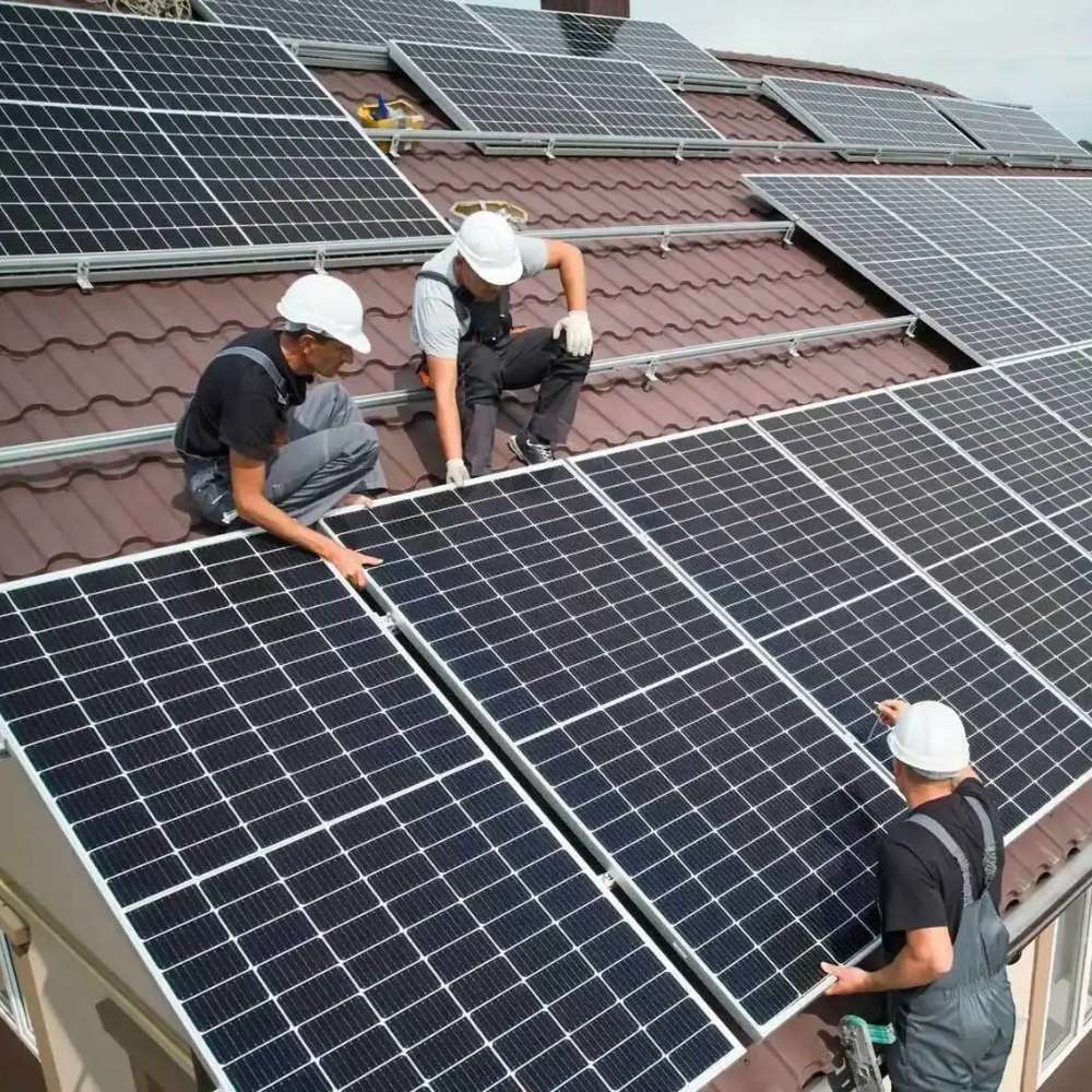 Three workers install solar panels on a rooftop, using power systems like the Victron Energy 25.6V 200Ah NG LiFePO4 Lithium Battery-BAT524120620
