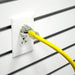 A 50ft yellow DuroMax extension cord plugged into a white socket, emphasizing its utility for quality generators and portable Duromax generators.