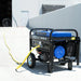 DuroMax XP4400E generator outdoors, connected to a bright yellow 100ft single tap extension cord, demonstrating the cord's reach and outdoor capability.