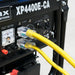 DuroMax generator's control panel with a connected yellow single tap extension cord, showcasing the power setup and clear plug design.