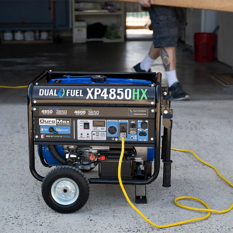 Duromax XP4850HX portable generator being used in a garage, showcasing its quality generator capabilities with dual fuel option.