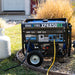 DuroMax portable generator XP4850HX set up outdoors with a propane tank, ready for use in a residential backyard.