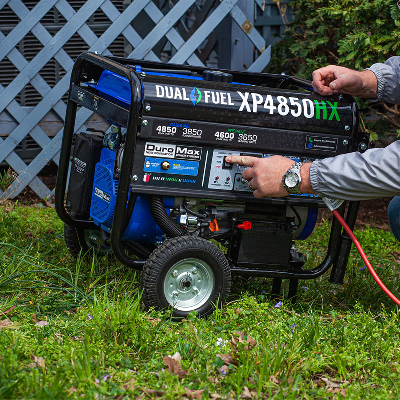 A person operating a Duromax XP4850HX quality generator outdoors, highlighting the ease of use of portable generators.