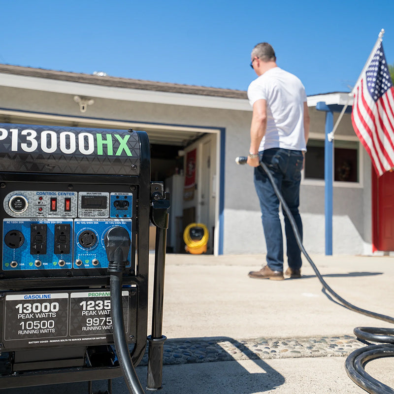 Hand inserting a Duromax generator cord into a home power backup outlet, signifying readiness for emergencies.