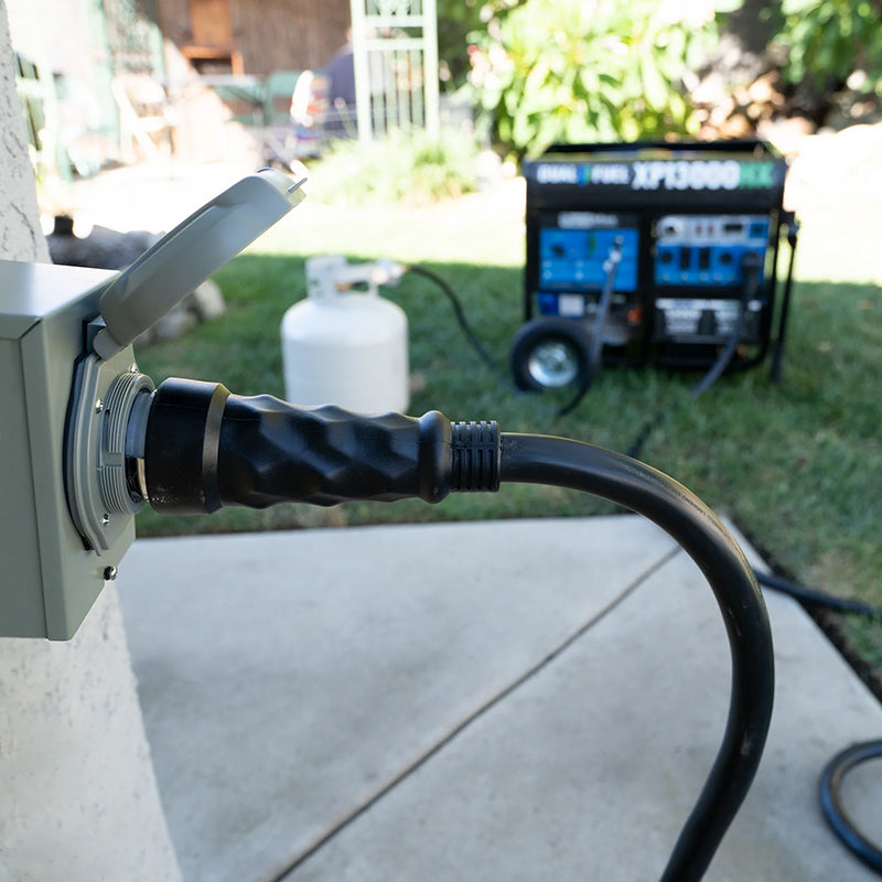 Duromax generator cord plugged into an outdoor power inlet box with a portable generator in the background, ideal for home power backup.