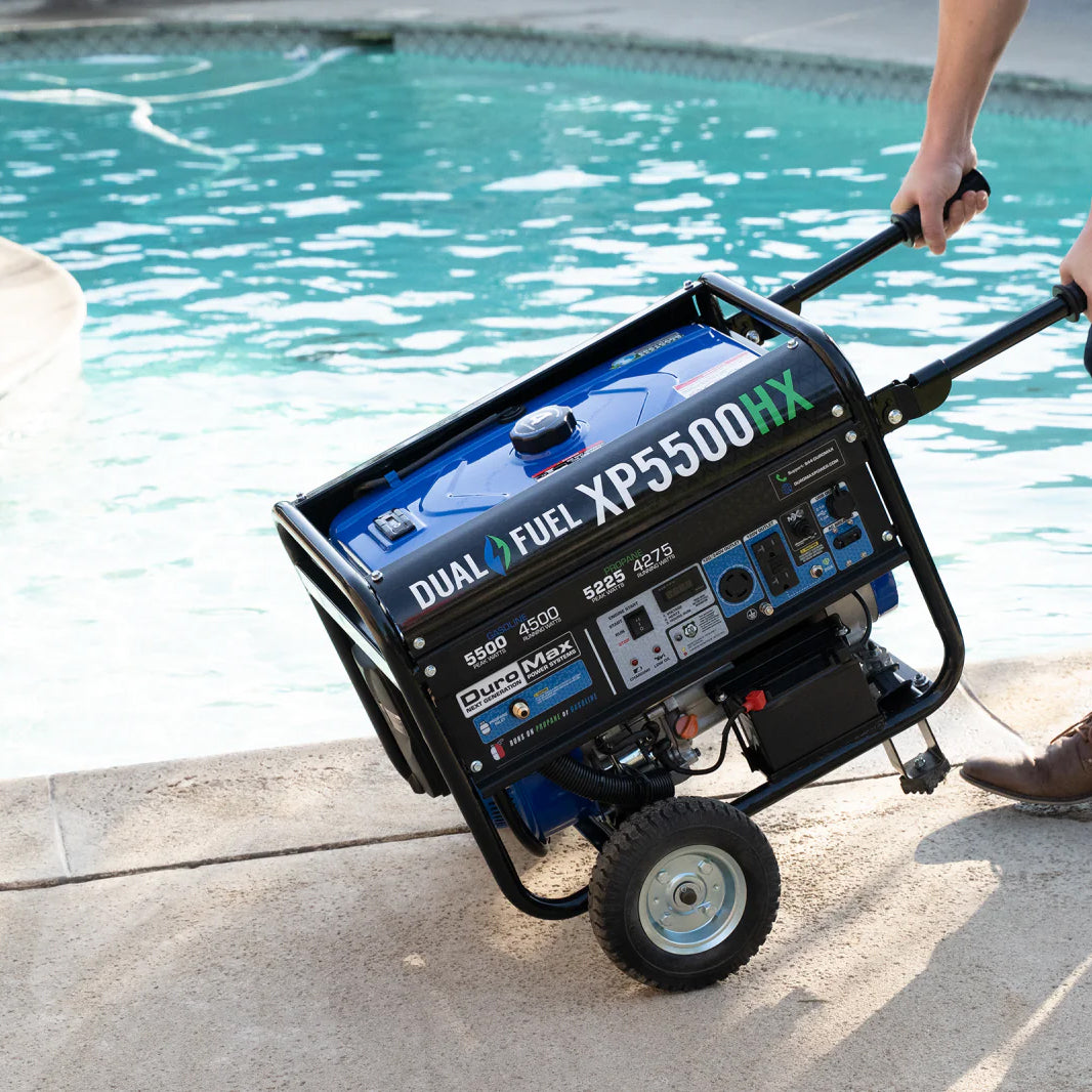 Duromax generator being maneuvered by a person near a swimming pool, suggesting its use for outdoor events or as a backup power source for home appliances.