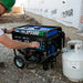 Worker using a Duromax XP5500HX quality generator, showcasing its functionality in a professional construction setting.