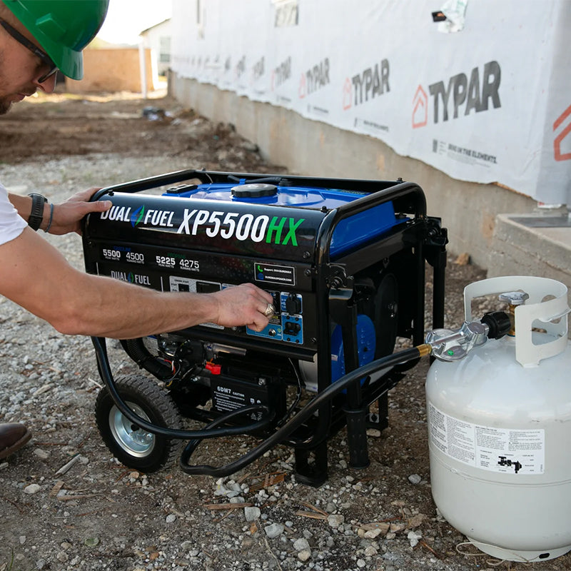 Worker using a Duromax XP5500HX quality generator, showcasing its functionality in a professional construction setting.