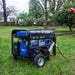 Person setting up a Duromax XP5500HX portable generator in a lush garden, illustrating its versatility in different environments.