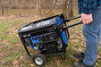 A person pushing a Duromax XP7500X portable generator, showcasing its user-friendly portability.