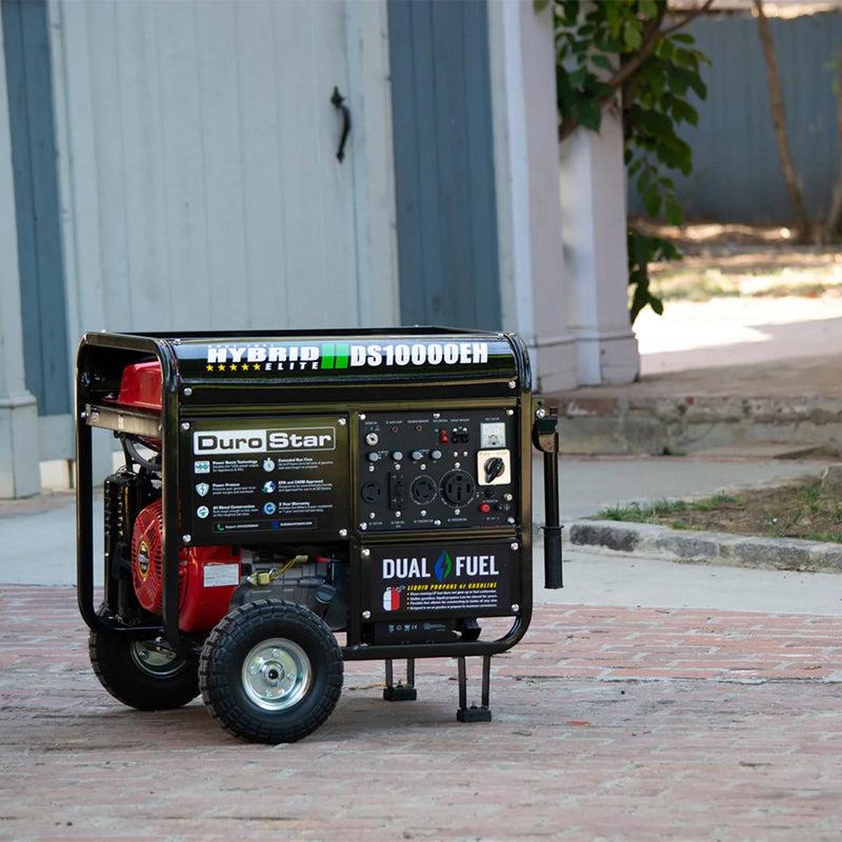 A distant view of the DuroStar DS10000EH quality generator positioned on a suburban driveway, showcasing its portability and compact size.