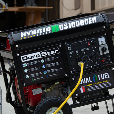 Close-up view of the DuroStar DS10000EH dual fuel quality generator with yellow power cord attached, showcasing its hybrid elite technology.