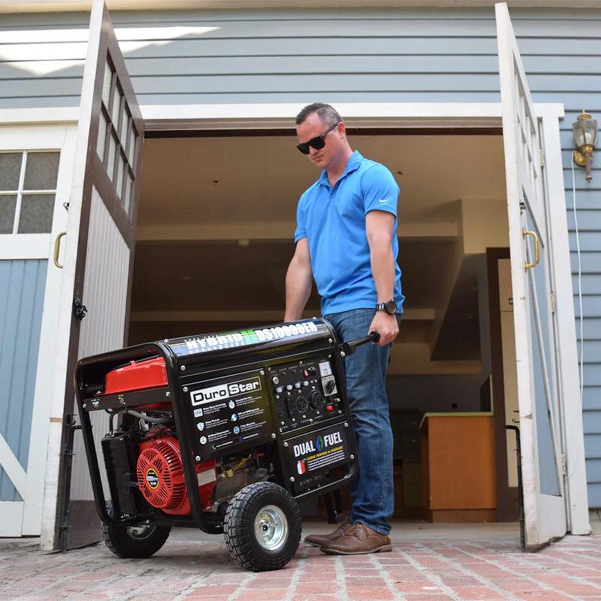 Easy-to-transport DuroMax DS10000EH portable generator with an extended handle for maneuverability, suitable for various settings.