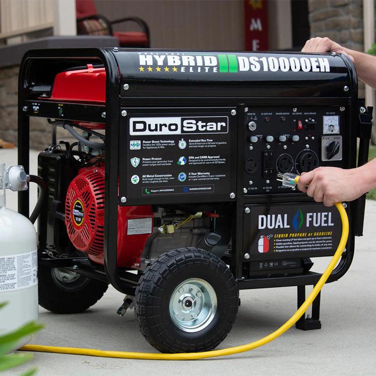 Man preparing the DuroStar DS10000EH generator for operation, showcasing its portable design and user-friendly features.