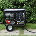 DuroStar DS12000EH Dual Fuel Generator ready for operation near a home's entrance, a versatile portable generator solution.