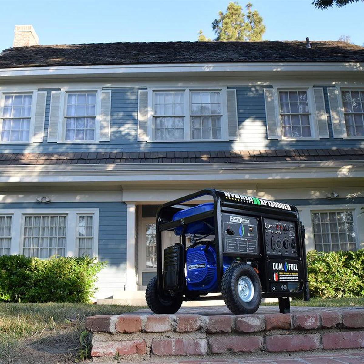 DuroMax XP13000EH quality generator placed in front of a classic home, ready for emergency power needs.