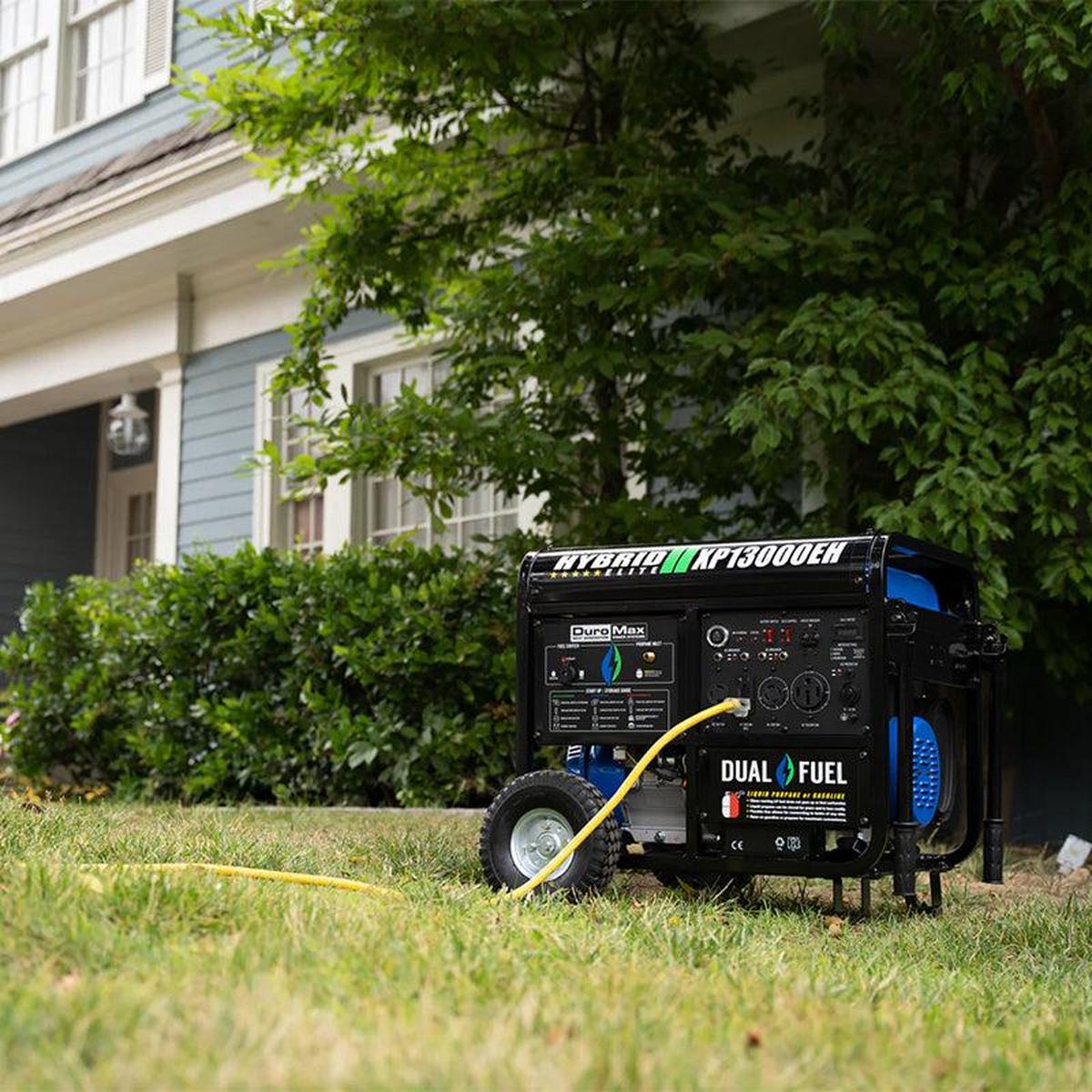 Blue DuroMax portable generator next to a propane tank on residential lawn.