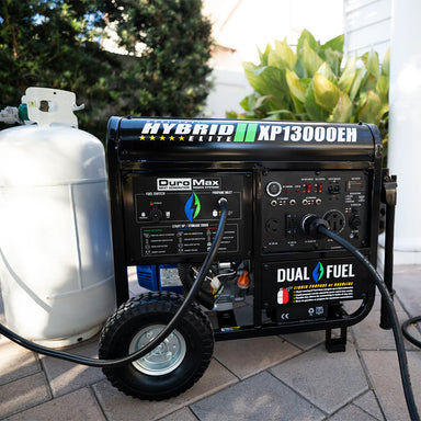 DuroMax XP13000EH generator displayed outside a house, showcasing its portability and size.