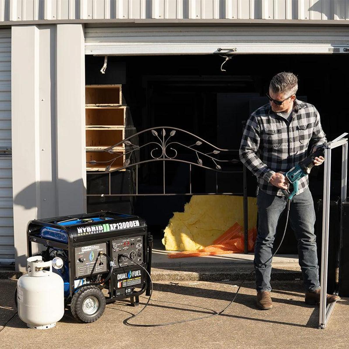 A craftsman using a DuroMax portable generator to power tools outdoors, demonstrating the generator's practical utility in home improvement projects.
