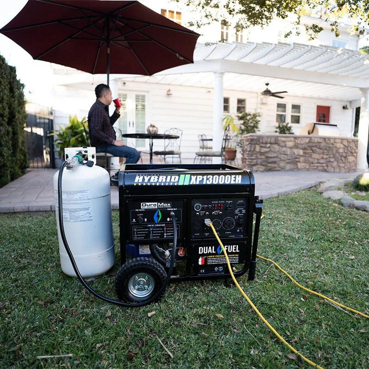 Man enjoying his backyard with a DuroMax hybrid generator, illustrating the comfort provided by a reliable portable power source.
