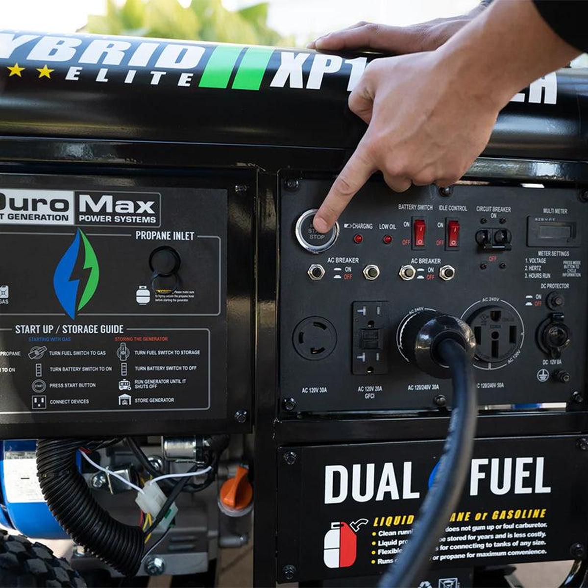 Close-up of a high-quality DuroMax portable generator control panel with a hand turning on the fuel switch and an extension cord connected.