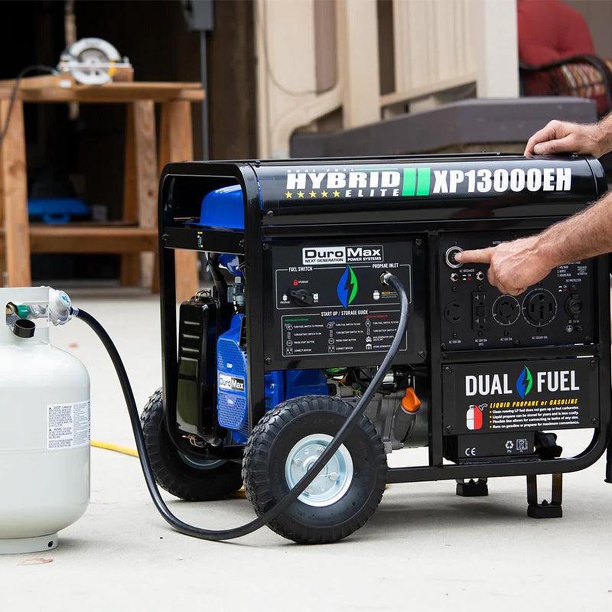 Close-up of a man operating a DuroMax XP13000EH portable generator, highlighting its user-friendly design and dual fuel capability.