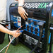 Connecting an extension cord to the fully featured power panel of the DuroMax XP15000HX generator.