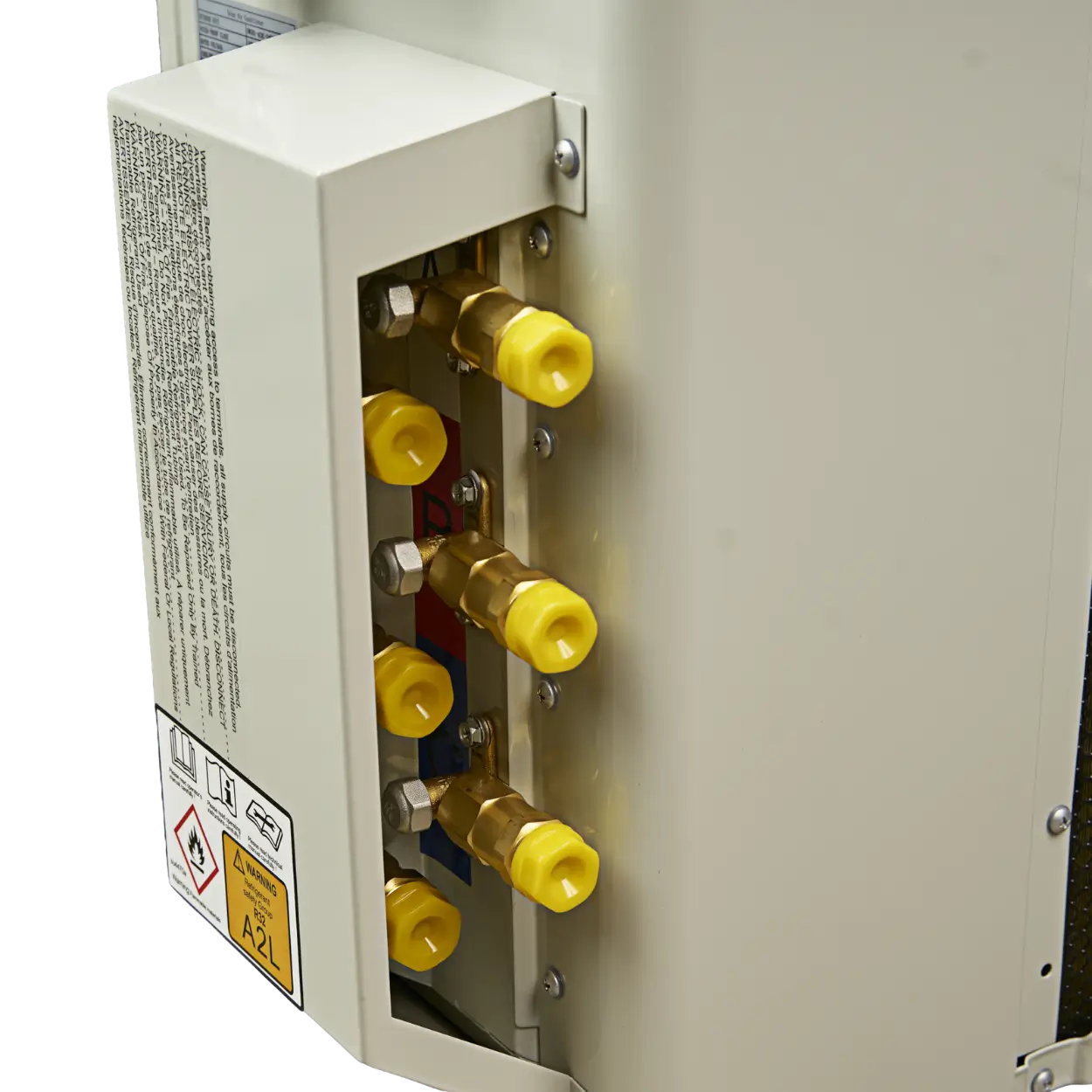 Close-up of a beige metal appliance or machinery component with a side panel removed, showing brass fittings and four bright yellow plastic caps on a white background.