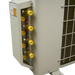 Close-up of a light gray metal air conditioner or heat pump outdoor unit showing the indoor connection side with brass and yellow fittings, a warning label, and part of the condenser coil.