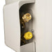 Close-up of a white mechanical component with gold and yellow knobs on a white background