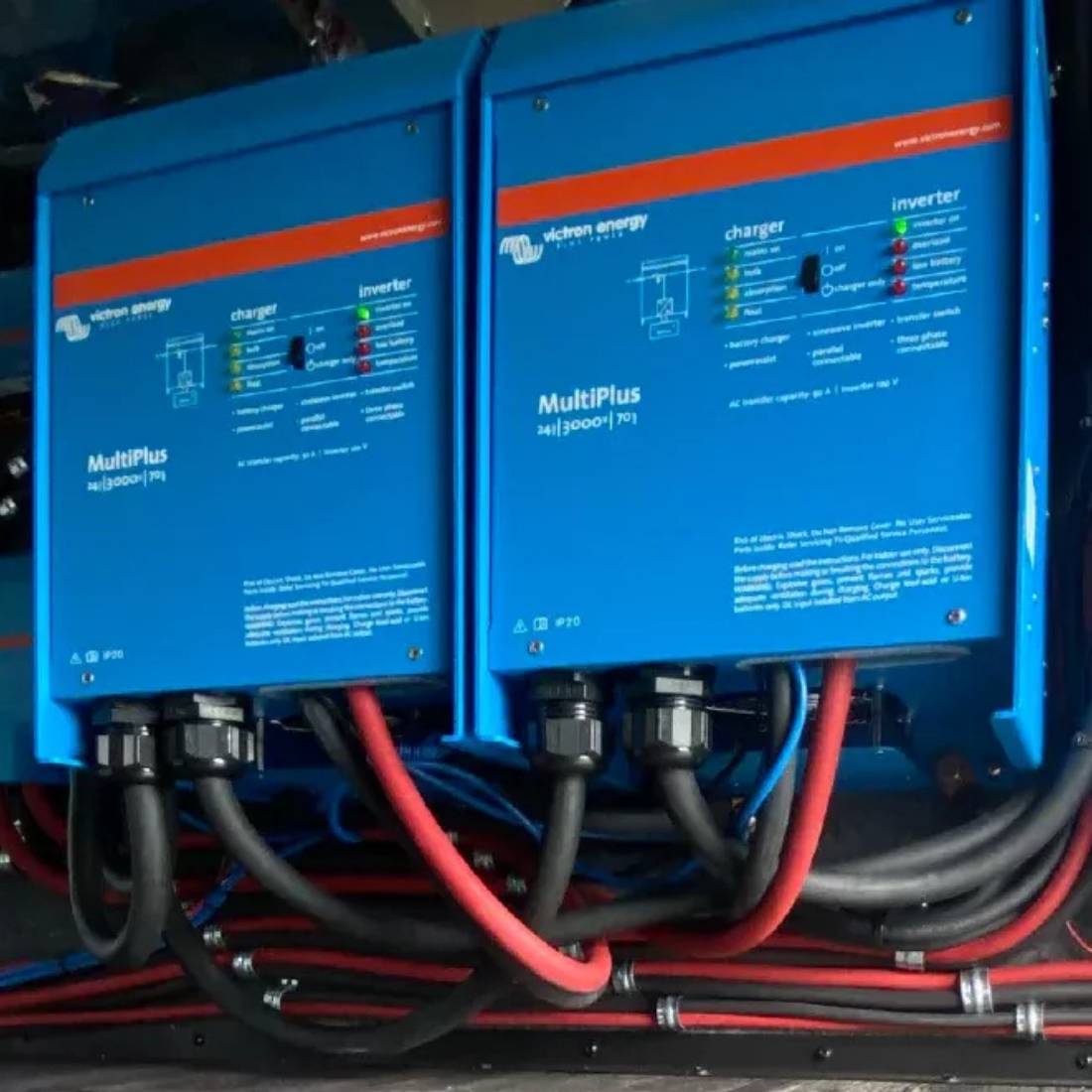 Dual Victron MultiPlus 3000W units installed with connected wiring for power distribution, featuring a compact and organized setup.