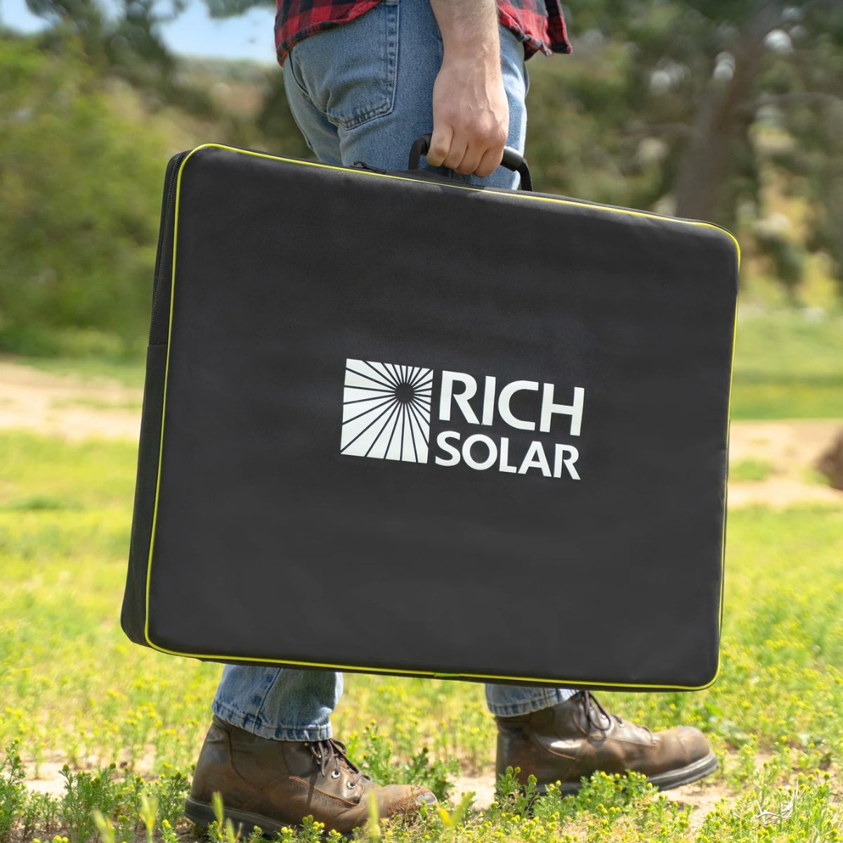 Rich Solar X100B MEGA 100W Portable Solar Panel Briefcase displaying its light weight carrying portability with its protective carrying bag.