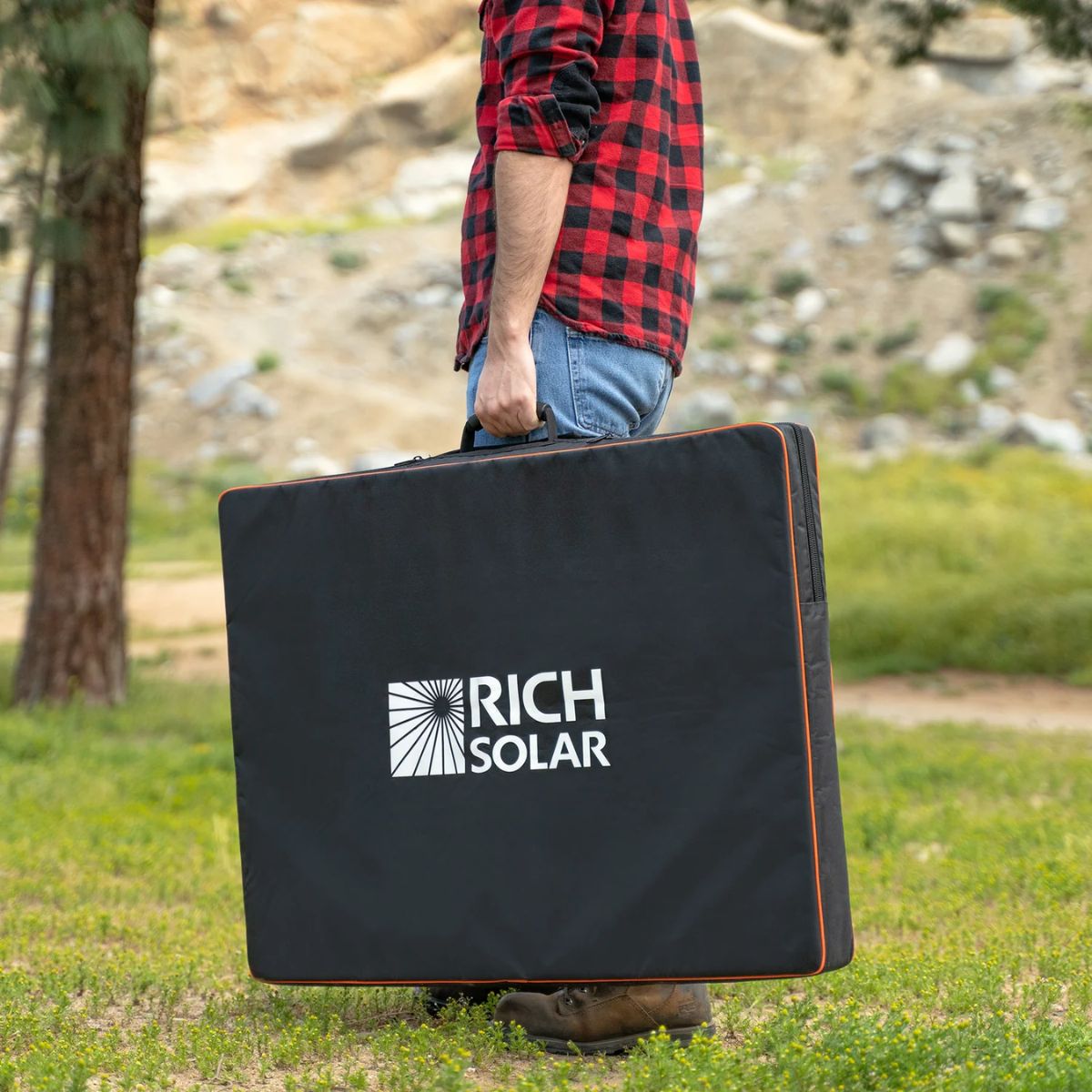 Rich Solar RS-X200B MEGA 200W Portable Solar Panel Briefcase displaying its light weight carrying portability with its protective carrying bag.